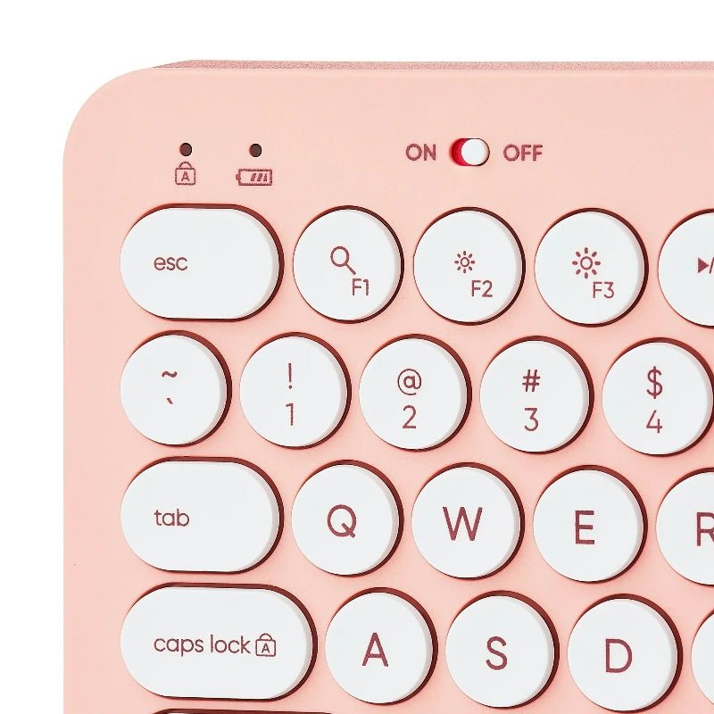 Primer plano de las teclas redondas blancas e interruptor ON/OFF del teclado ONN rosado